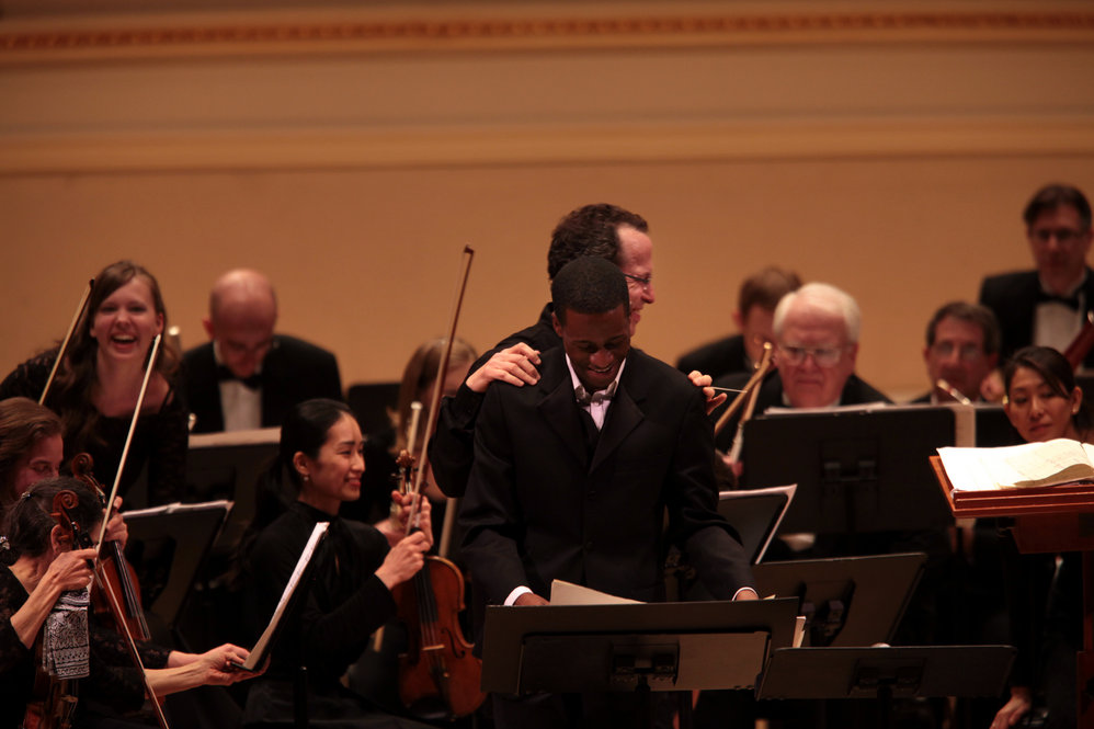Baritone Nathan De'Shon Myers is congratulated by music director David Alan Miller after receiving a standing ovation for his performance of "The Spirituals Project" with the Albany Symphony.