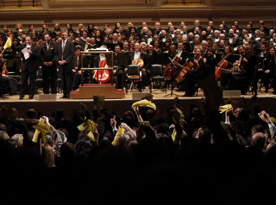 Members of the Carnegie Hall audience wave their speical yellow bandanas to signify that they are from Texas before the Dallas Symphony Orchestra concert at the Spring for Music festiva at Carnegie Hall.