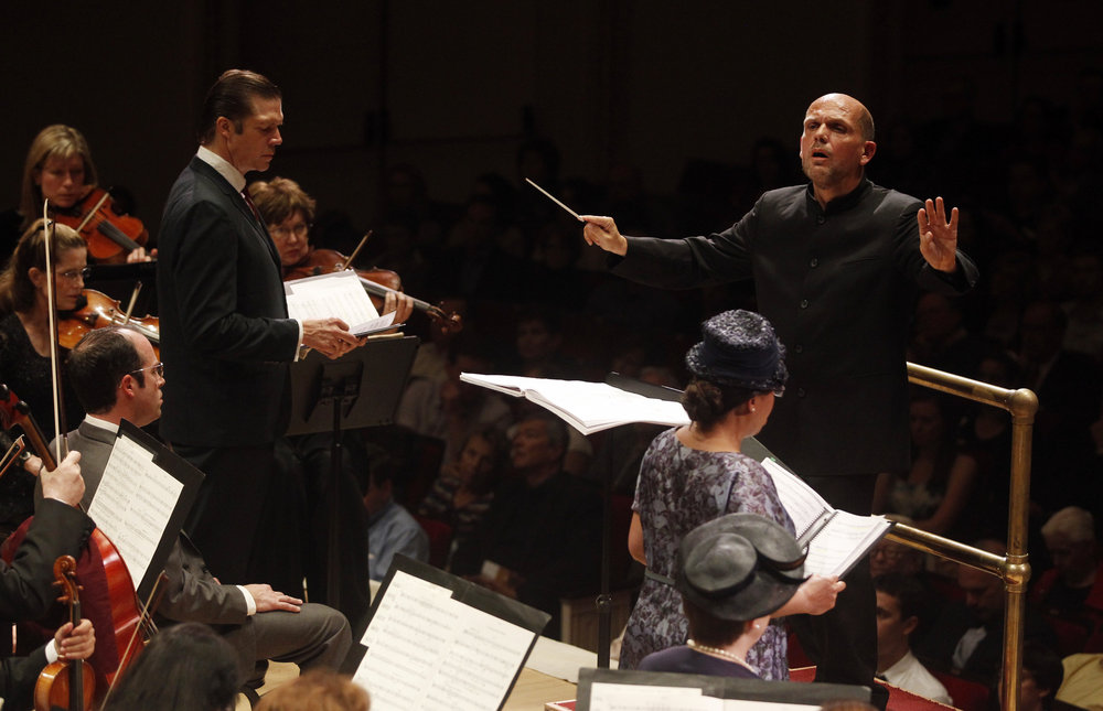 Conductor Jaap van Zweden leads the Dallas Sympphony and Chorus, with soloists Rod Gilfry (left) as LBJ, and soprano Indira Mahajan (right) as Mrs. Chaney, one of the mothers of the slain civil rights workers.
