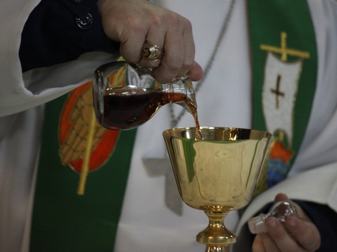 Sept. 2010 file photo: A chaplain pours wine in preparation for communion during a Sunday church service aboard the USS Kearsarge.