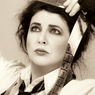 British singer Kate Bush acts out the title to her new album, Director's Cut.