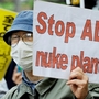 A man holds a placard during a march denouncing the use of nuclear plants and power during a demonstration in Tokyo on May 1. A man holds a placard during a march denouncing the use of nuclear plants and power during a demonstration in Tokyo on May 1.