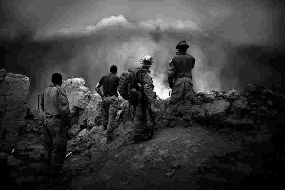 Marines watch as a massive dust storm approaches their base. Though fighting slows during poppy harvest, Marines remain on edge, as fighting could erupt at any moment.