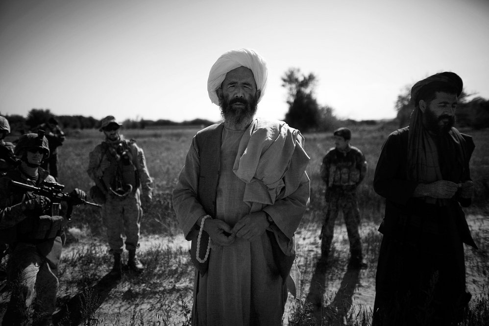 A local farmer talks with Marines in the "green zone" -- a strip of irrigated land along the main Helmand River, also a hotbed for insurgency and violent fighting after poppy cultivation ends.