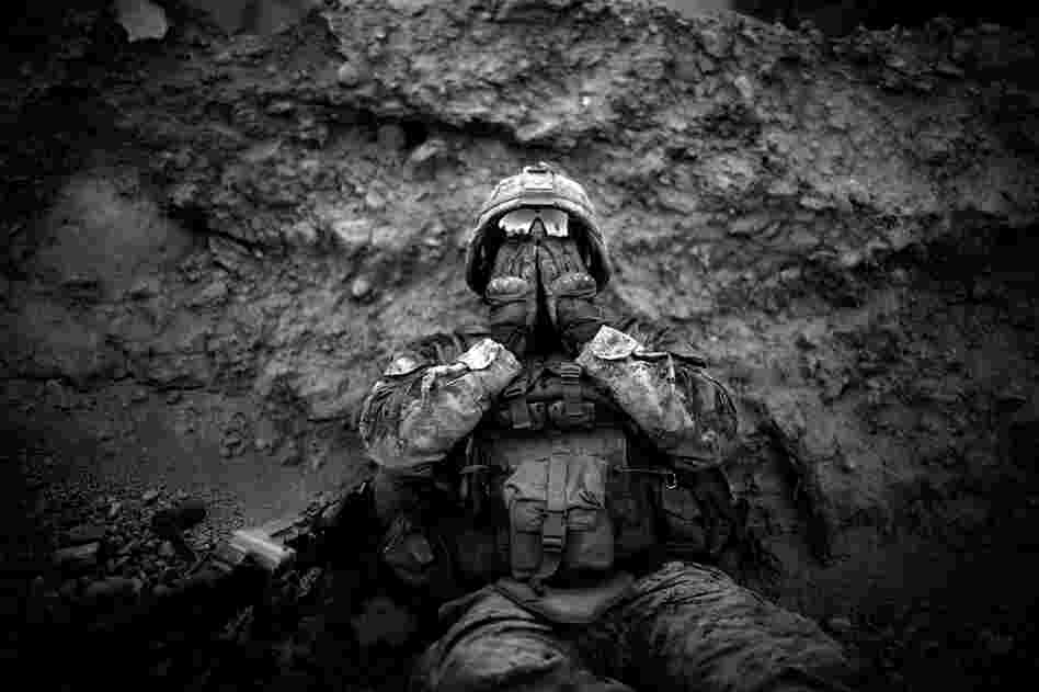 Lance Cpl. Anthony Espinoza wipes the salt and sweat out of his eyes at the end of a daylong patrol. The 100-degree temperatures and humidity of the flooded farm fields make walking and patrolling in the area a daily battle.