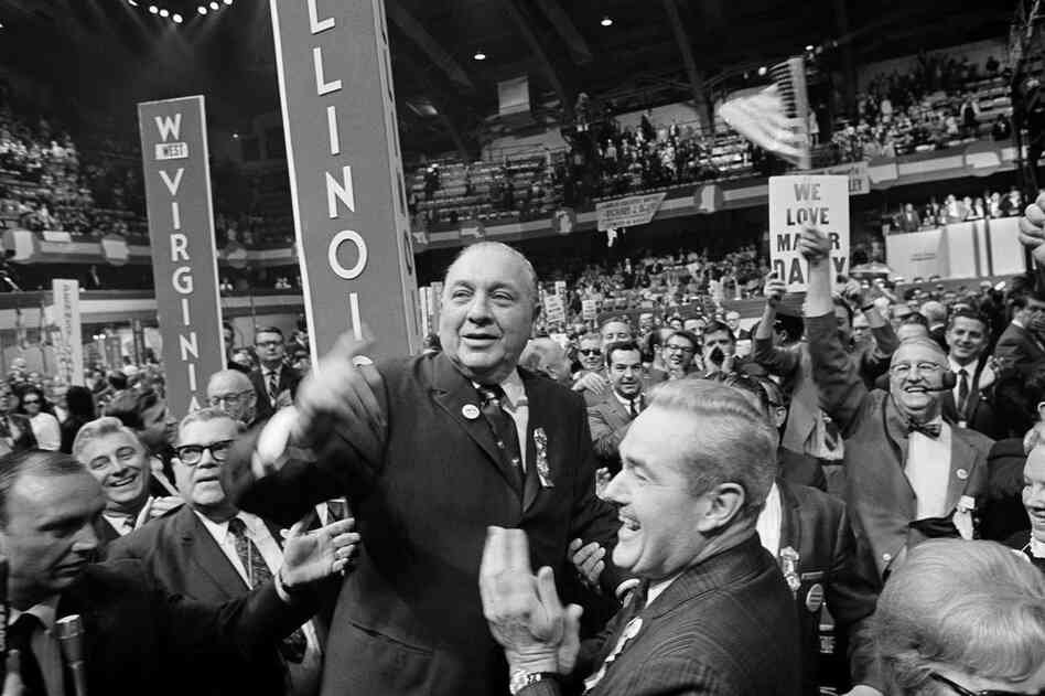 Illinois delegates cheer Mayor Richard J. Daley as he arrives on the convention floor for the closing session of the Democratic National Convention on Aug. 29, 1968, in Chicago — a day after the infamous riot between Chicago police and demonstrators.  