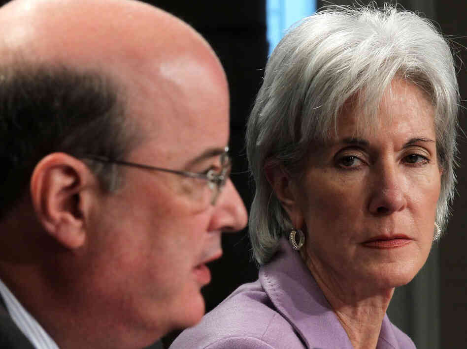 Health and Human Services Secretary Kathleen Sebelius listens as Social Security Administration Commissioner Michael Astrue speaks during a Friday news briefing on Social Security and Medicare.
