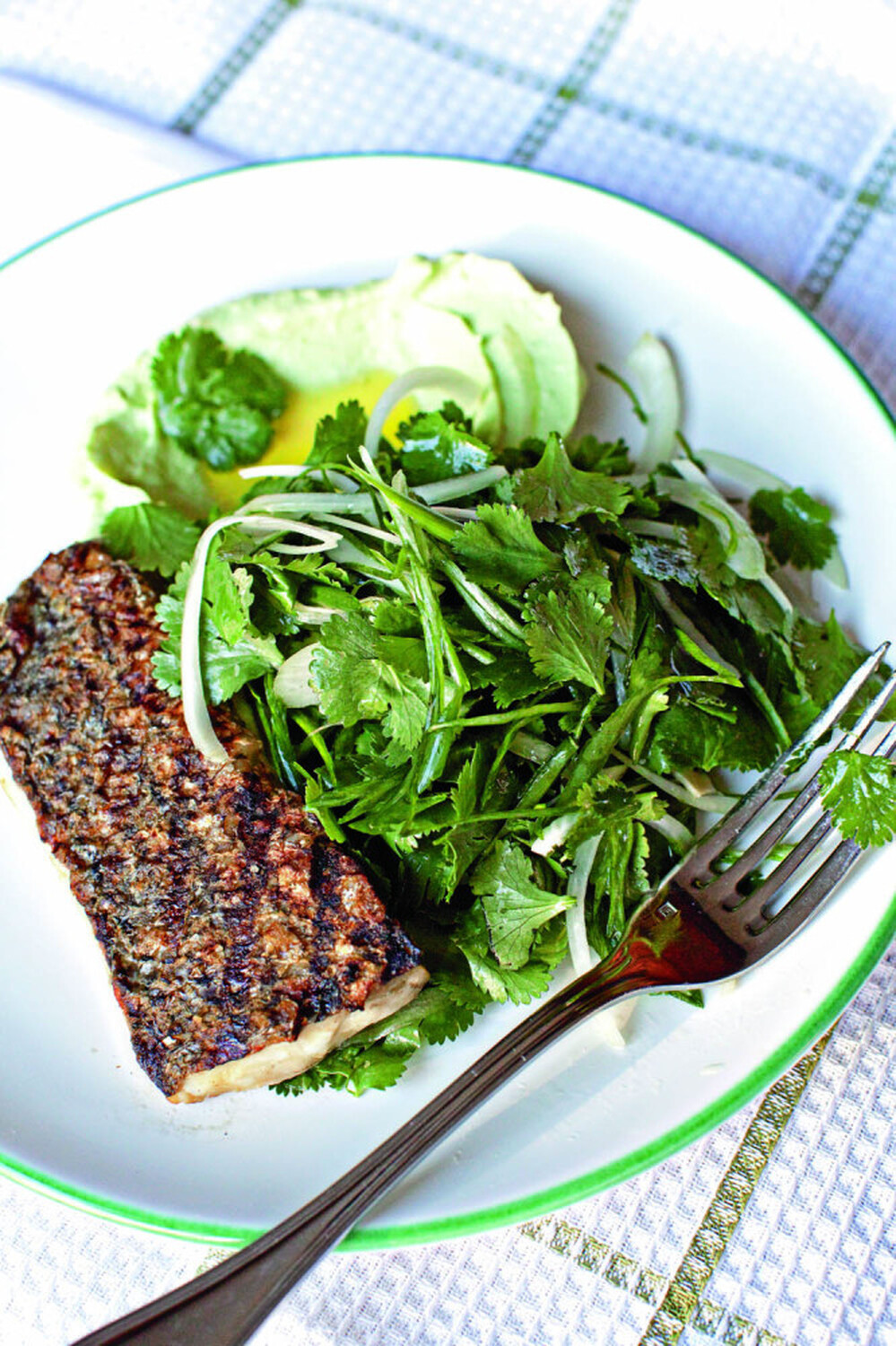 For Cod and Country pairs inventive combinations of fish and fresh vegetables and suggests substitutes for over-harvested fish species. Above, wild striped bass with cilantro-onion salad and yogurt-avocado puree. Click here for this and other recipes.