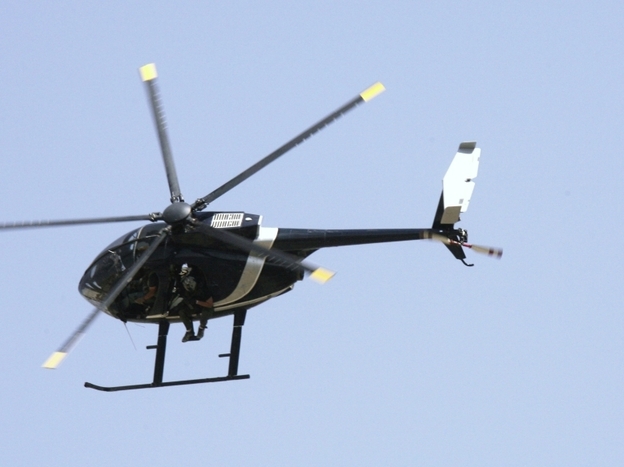 Blackwater security contractors are seen in a helicopter in Baghdad in 2007. The company changed its name to Xe in 2009, amid controversy surrounding the killing of 17 Iraqi civilians in 2007.