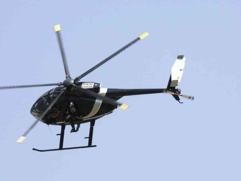 Blackwater security contractors are seen in a helicopter in Baghdad in 2007. The company changed its name to Xe in 2009, amid controversy surrounding the killing of 17 Iraqi civilians in 2007.