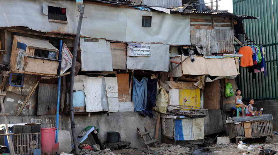 Filipino children sit in front of their slum homes in Manila, Philippines. Activists are trying to organize slum dwellers in order to provide them with a political voice. Filipino children sit in front of their slum homes in Manila, Philippines. Activists are trying to organize slum dwellers in order to provide them with a political voice.