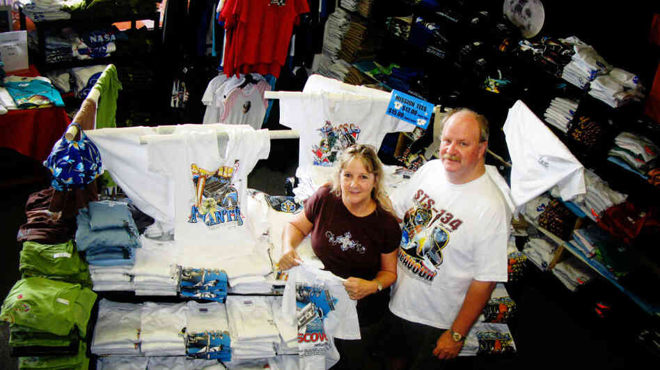 Brenda Mulberry runs a T-shirt and custom merchandise shop just a few miles from Kennedy Space Center. Her husband, Gerry, was let go last month after spending most of his adult life working as a contractor on NASA's shuttle program. Brenda Mulberry runs a T-shirt and custom merchandise shop just a few miles from Kennedy Space Center. Her husband, Gerry, was let go last month after spending most of his adult life working as a contractor on NASA's shuttle program.