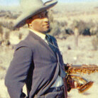 William Claxton's cover photo of Sonny Rollins standing in the desert — sporting a cowboy hat, gun holster and humorously knowing look — has only added to Way Out West's classic status. William Claxton's cover photo of Sonny Rollins standing in the desert — sporting a cowboy hat, gun holster and humorously knowing look — has only added to Way Out West's classic status.