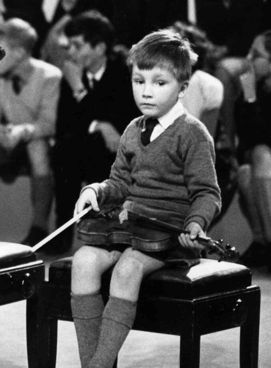 This lad looks less than enthused about classical music. (Actually, it's a very young Nigel Kennedy, captured by a cameraman in 1964.)