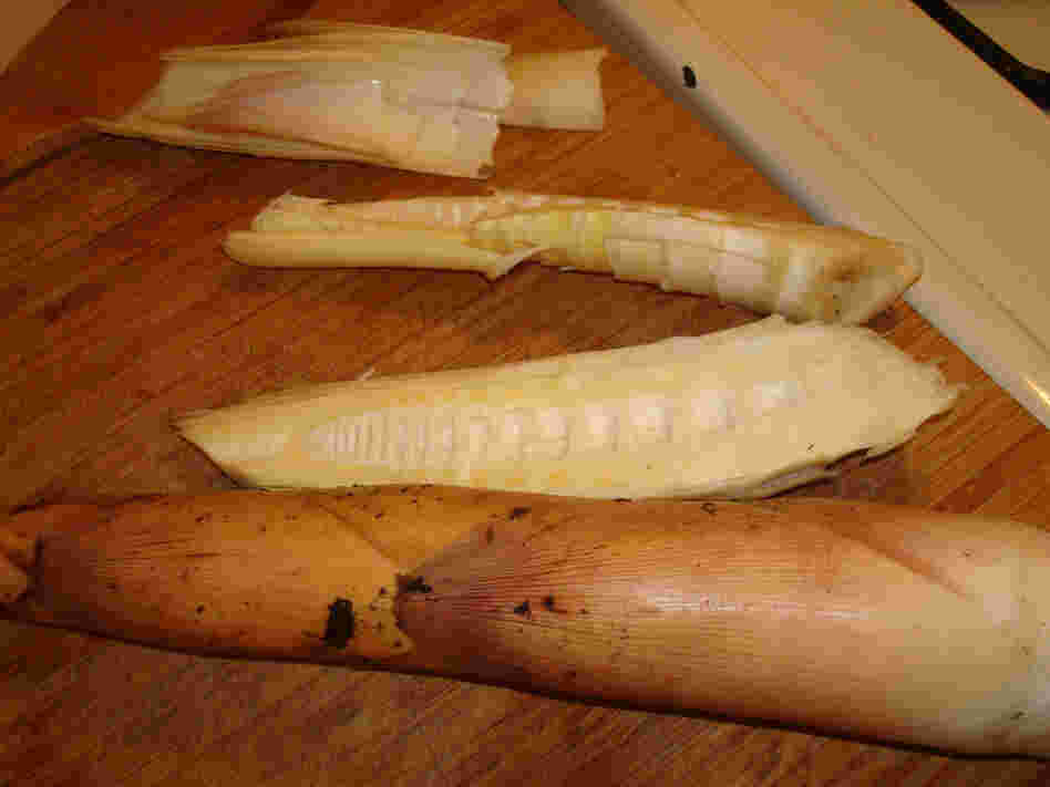 Peeling back the outer leaves of the bamboo shoot reveals the delicate champagne-colored inner leaves (top left). The shoots are sliced vertically after they're boiled and cooled.