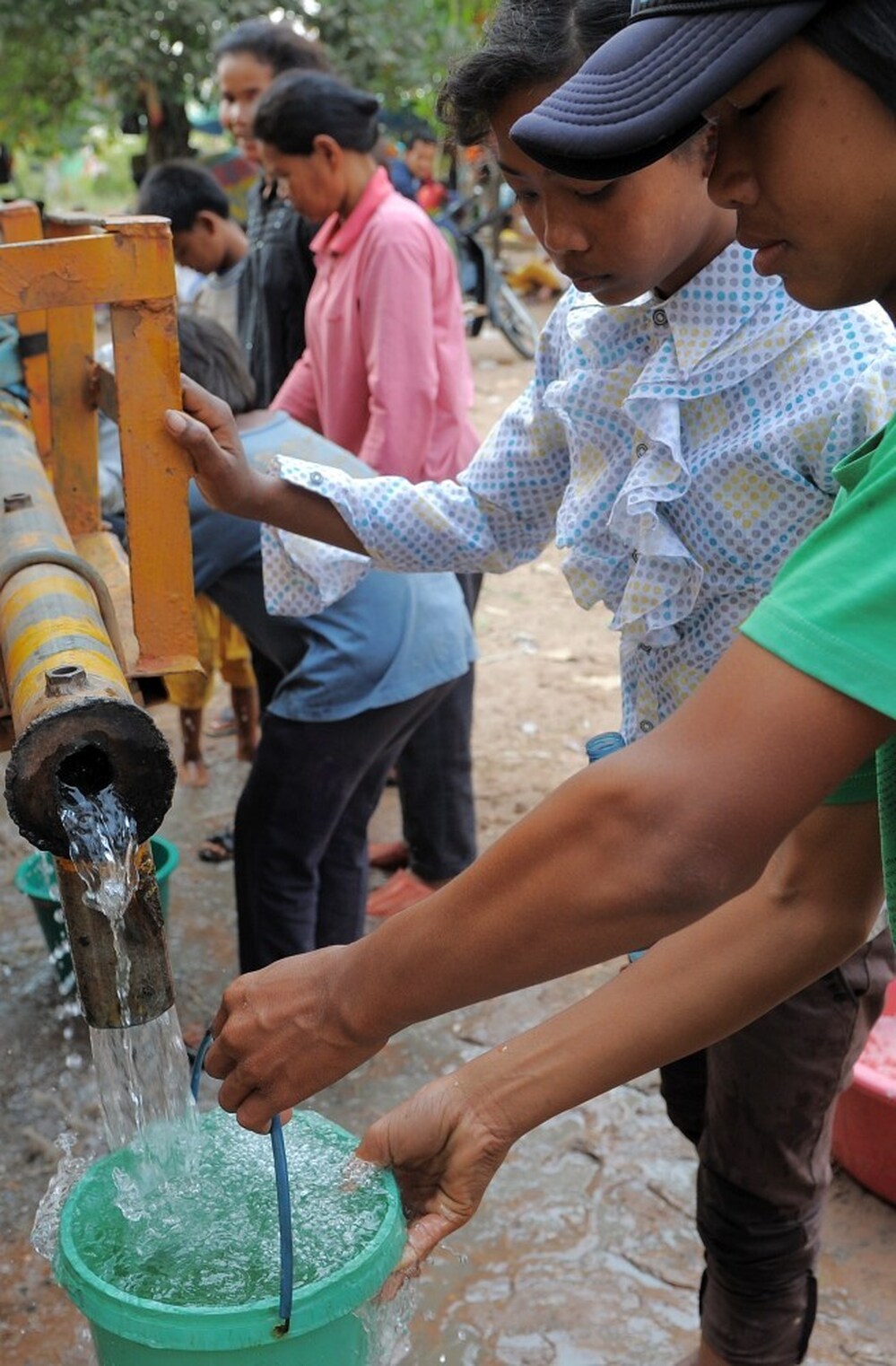 Cambodian villagers get water from a truck at a camp in Preah Vihear province, some 300 miles northwest of Phnom Penh. Though 92 percent of households in Phnom Penh have clean running water, many in rural Cambodia rely on trucks or water purification tablets.