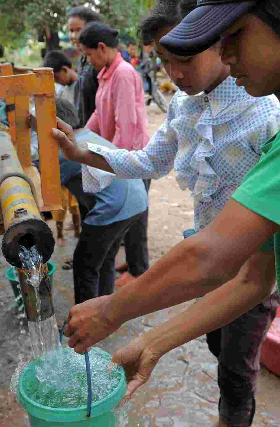 Cambodian villagers get water from a truck at a camp in Preah Vihear province, some 300 miles northwest of Phnom Penh. Though 92 percent of households in Phnom Penh have clean running water, many in rural Cambodia rely on trucks or water purification tablets.