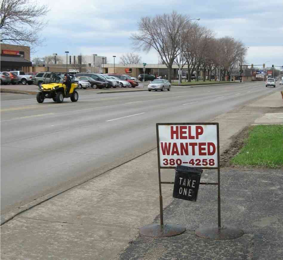 A sign in front of a janitorial service demonstrates the shortage of workers in Aberdeen, S.D.