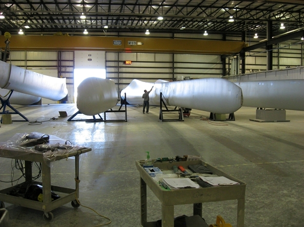 A worker at Molded Fiber Glass in Aberdeen works on a wind turbine blade. The company broke ground in 2007, but has never been able to fully staff its operation. Now it's looking to expand to add another blade to its product line.