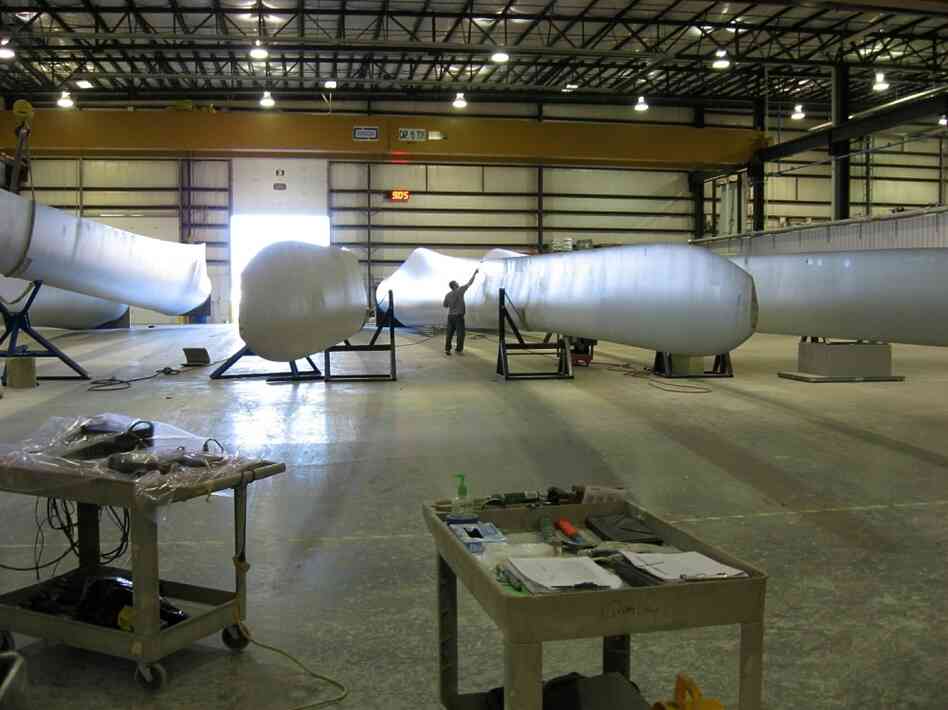 A worker at Molded Fiber Glass in Aberdeen works on a wind turbine blade. The company broke ground in 2007, but has never been able to fully staff its operation. Now it's looking to expand to add another blade to its product line.