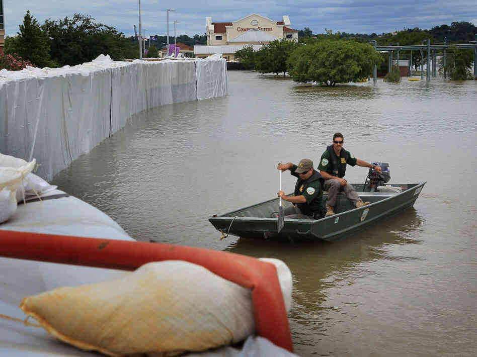 Louisiana Department of Wildlife and Fisheries officers patrol along a levee constructed around a medical center to hold back floodwater from the Mississippi River on Monday in Vidalia, La. Louisiana Department of Wildlife and Fisheries officers patrol along a levee constructed around a medical center to hold back floodwater from the Mississippi River on Monday in Vidalia, La.