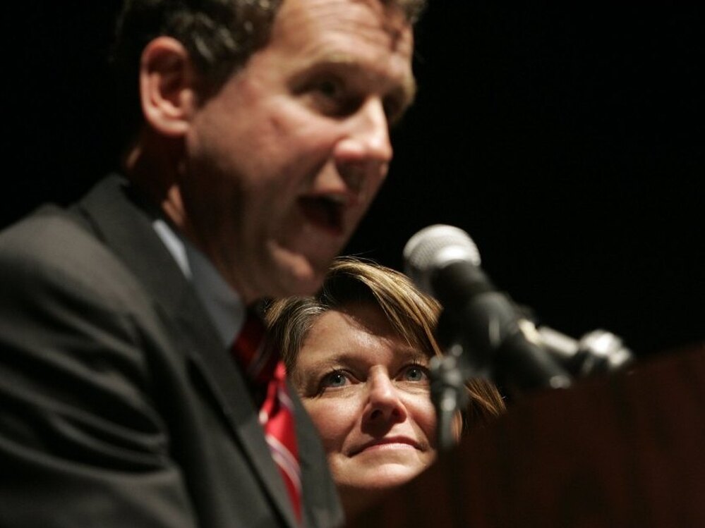 Connie Schultz, a Pulitzer Prize-winning journalist, watches as her husband, Ohio Democrat Sherrod Brown, gives his victory speech after being elected senator in 2006.