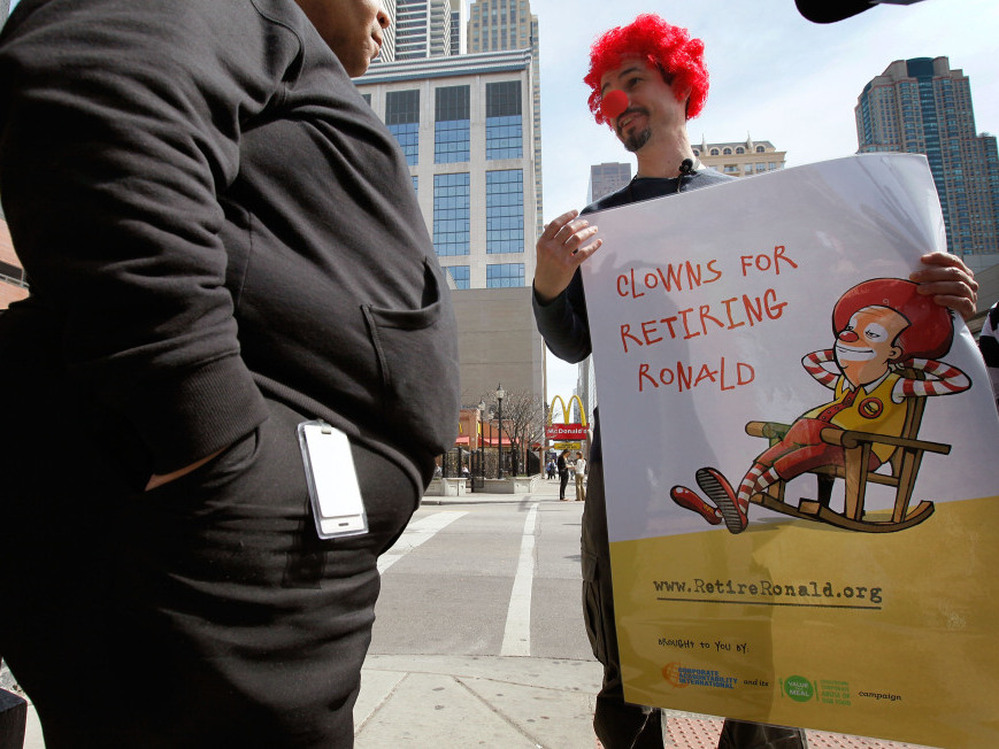 During a demonstration in Chicago, Jack Nugent (right), part of a group organized by Corporate Accountability International, urged a pedestrian to support his cause calling for McDonald's to retire Ronald McDonald in March 2010.