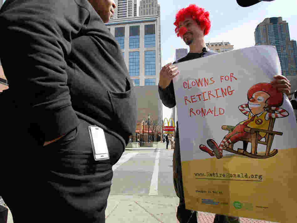 During a demonstration in Chicago, Jack Nugent (right), part of a group organized by Corporate Accountability International, urged a pedestrian to support his cause calling for McDonald's to retire Ronald McDonald in March 2010.