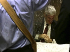 Image from video: A protester dumps glitter on a table where GOP presidential hopeful Newt Gingrich and his wife, Callista, were signing books at a hotel in Minneapolis, on Tuesday (May 17, 2011). Image from video: A protester dumps glitter on a table where GOP presidential hopeful Newt Gingrich and his wife, Callista, were signing books at a hotel in Minneapolis, on Tuesday (May 17, 2011).