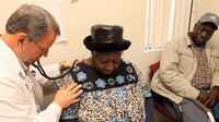Dr. David Gilder gives Sally Johnson a checkup at the Mallory Community Health Center in Tchula, Miss., a town located in Holmes County.