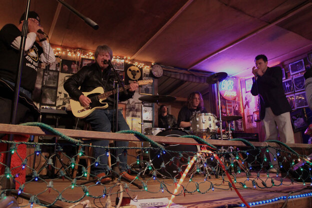 A warm-up band at Gip's Place features a rookie harmonica player.