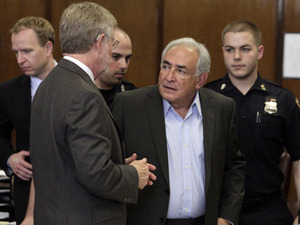 Former International Monetary Fund leader Dominique Strauss-Kahn (center) talks with his attorney William Taylor (left) as he leaves court court after his bail hearing in New York state Supreme Court,  Thursday, May 19, 2011.