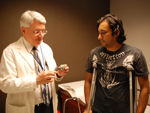 Orthopedic surgeon Joshua Jacobs examines patient Ali Hussein who recently received an artificial hip with a plastic lining between a metal ball and socket. Orthopedic surgeon Joshua Jacobs examines patient Ali Hussein who recently received an artificial hip with a plastic lining between a metal ball and socket.