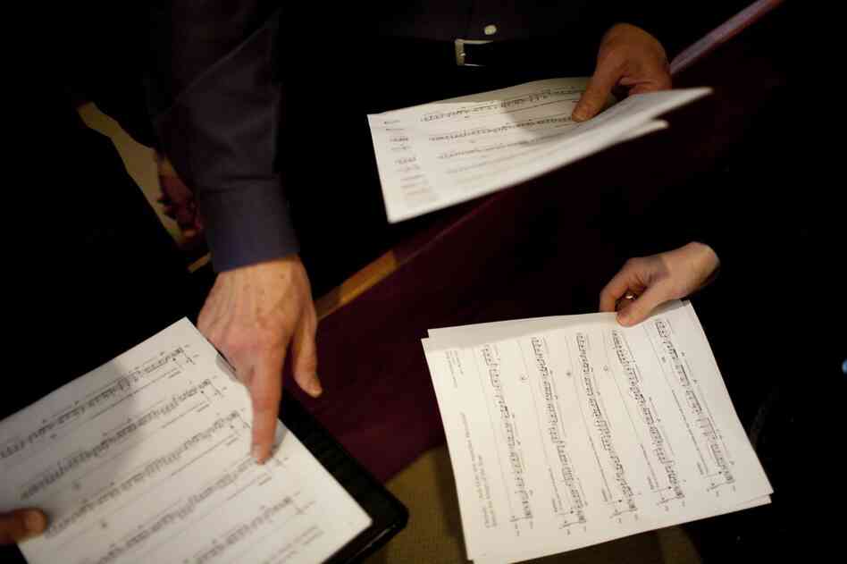 Kyr reviews the musical score with members of Conspirare prior to rehearsal.