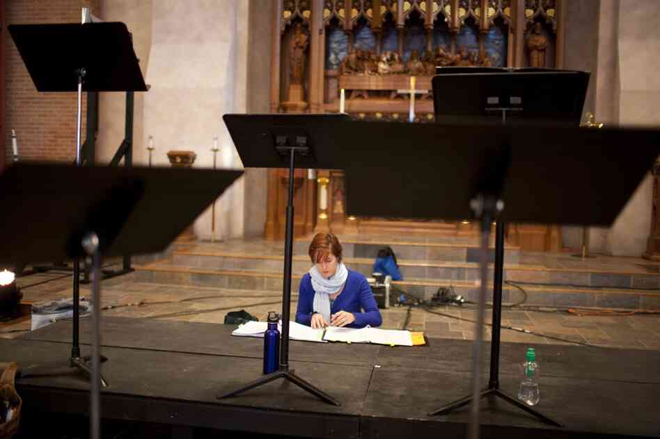 Dorea Cook, who sings alto with Conspirare, looks over her sheet music during a break from rehearsal.