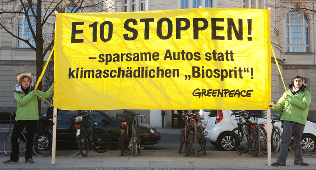 Greenpeace activists display a banner reading: "Stop E10! Fuel-efficient cars instead of harmful biofuel!" outside the economy ministry in Berlin on March 8. The ministry was holding an E10 biofuel summit that day.