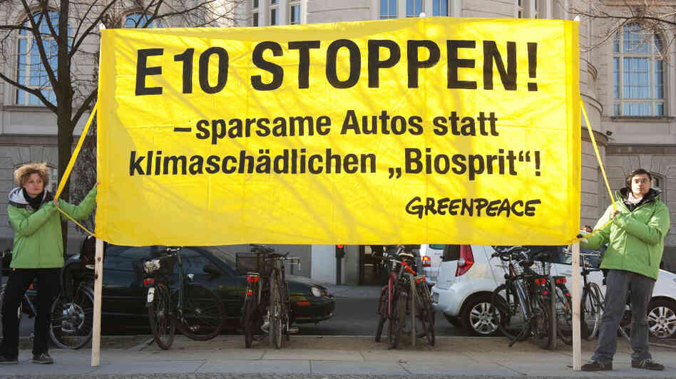 Greenpeace activists display a banner reading: "Stop E10! Fuel-efficient cars instead of harmful biofuel!" outside the economy ministry in Berlin on March 8. The ministry was holding an E10 biofuel summit that day.