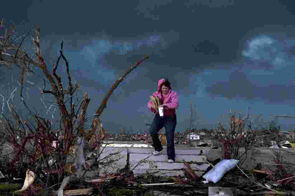 Janet Martin attempts to salvage items from her brother's home in Joplin. "Twenty minutes before the storm, he left to go to church.  He would have been in that basement if he hadn't gone," Martin said. 