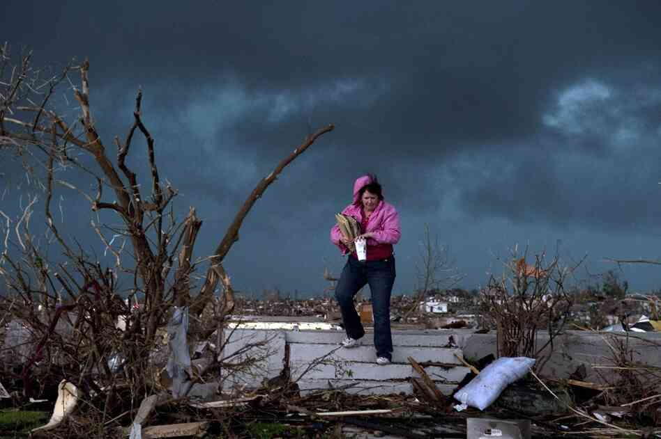 Janet Martin attempts to salvage items from her brother's home in Joplin. "Twenty minutes before the storm, he left to go to church.  He would have been in that basement if he hadn't gone," Martin said. 