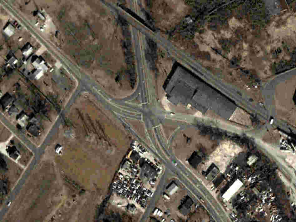 An aerial photograph shows the Rozzelles Ferry Road and W. Trade Street intersection, before it was improved.