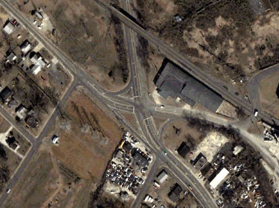 An aerial photograph shows the Rozzelles Ferry Road and W. Trade Street intersection, before it was improved.