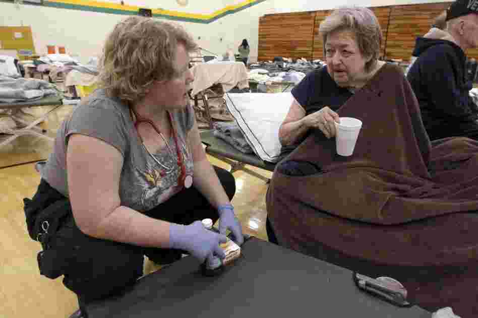 Delma Boyd of Joplin, Mo., (right) talks with medical technician Angela O'Leary of Purdy, Mo., in a temporary American Red Cross shelter at Missouri Southern State University in Joplin. 