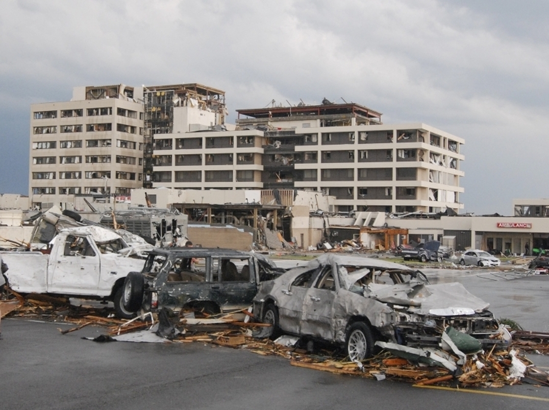 Damaged vehicles litter the parking lot of St. John's Regional Medical Center in Joplin, Mo., after a tornado hit the southwest Missouri city Sunday evening.