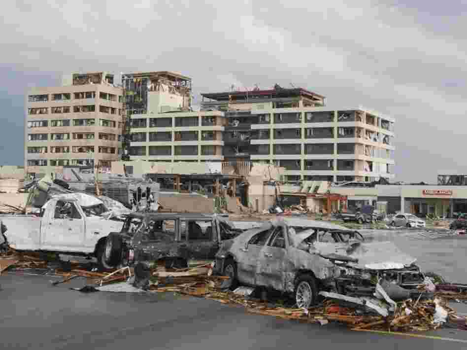 Damaged vehicles litter the parking lot of St. John's Regional Medical Center in Joplin, Mo., after a tornado hit the southwest Missouri city Sunday evening.