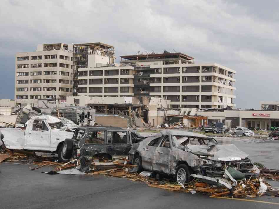 Damaged vehicles litter the parking lot of St. John's Regional Medical Center in Joplin, Mo., after a tornado hit the southwest Missouri city Sunday evening.
