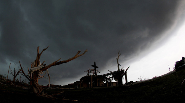 A cross stood atop a church that was severely damaged by a tornado Sunday in Joplin, Mo., as a severe storm passed overhead earlier today (May 23, 2011).