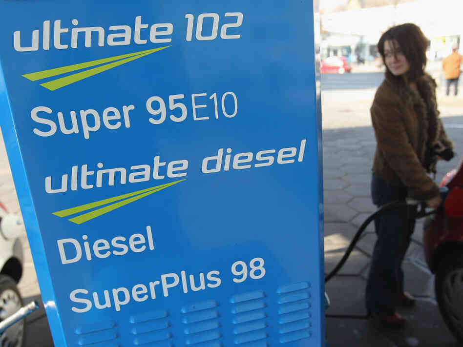 A woman fills her tank with E10 gasoline in Berlin on March 4. Delivery of the fuel, which is a blend of gasoline and 10 percent ethanol, has stopped because consumers are not buying enough of it.
