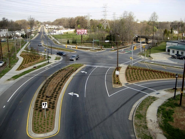 Cities like Charlotte, N.C., are moving to improve roadways for pedestrians and cyclists. Above, a street project on Rozzelles Ferry Road, which now has bike lanes and extended sidewalks. Below, an aerial photo of the intersection before work began.