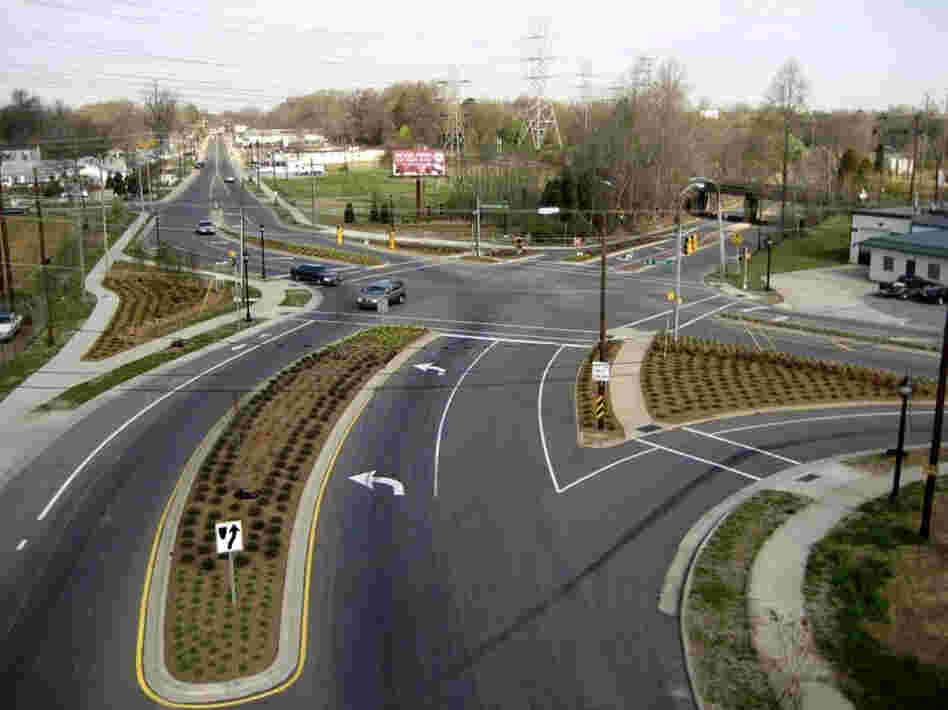 Cities like Charlotte, N.C., are moving to improve roadways for pedestrians and cyclists. Above, a street project on Rozzelles Ferry Road, which now has bike lanes and extended sidewalks. Below, an aerial photo of the intersection before work began.