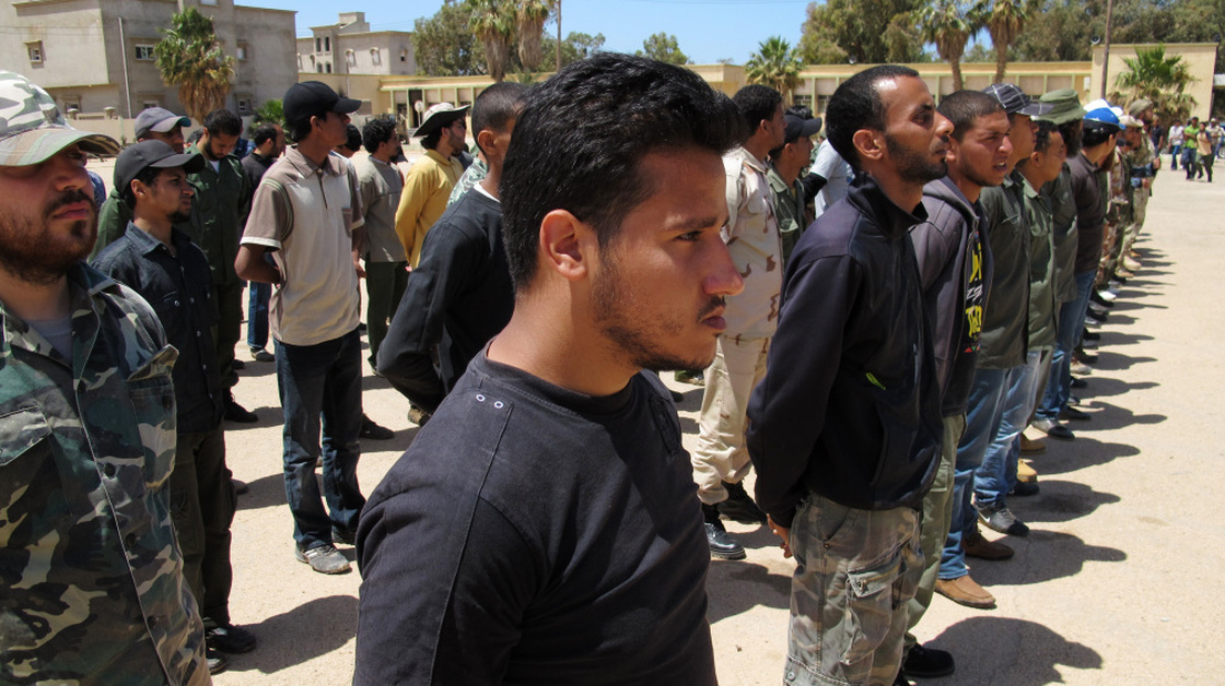 Volunteers attend a boot camp for rebels at a captured Libyan army base in Benghazi.  Those with some military experience train for a week or two; the rest get three weeks or more.